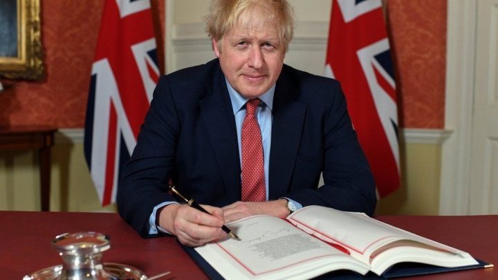 Prime Minister Boris Johnson signing the Brexit Withdrawal Agreement in 2020.